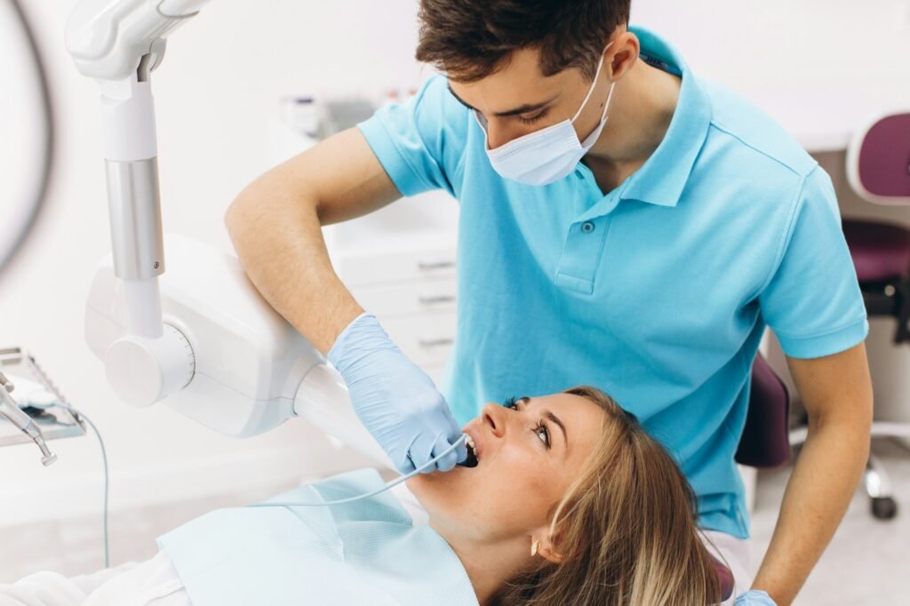 A dentist makes X-ray for woman in a dental clinic