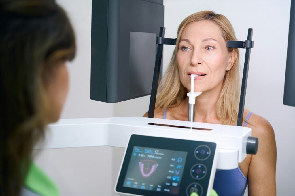 Adult woman getting orthopantomography in dental clinic